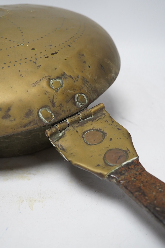 A 17th century brass and iron warming pan, 112cm. Condition - poor